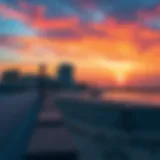 A serene view of Bateen Beach at sunset, showcasing the vibrant colors of the sky and water