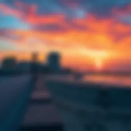 A serene view of Bateen Beach at sunset, showcasing the vibrant colors of the sky and water